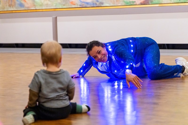 Baby and dancer, looking at each other